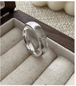 Close-up of S925 sterling silver ring featuring spiral texture and internal hallmark