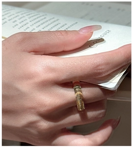 Close-up of golden S925 silver ring featuring a distinct horizontal textured surface