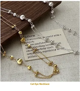 Detailed close-up of double-layer cat eye bead necklaces in gold and silver finish