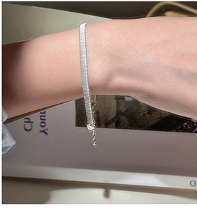 Close-up of S925 sterling silver woven bracelet with adjustable chain on a wrist