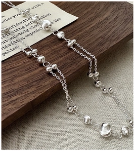 Detailed view of S925 sterling silver double-layered chain with cat eye beads and brushed beads