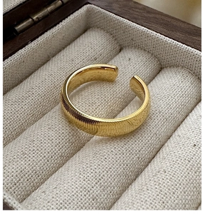 Detail of golden adjustable ring with vertical ridge texture in jewelry box