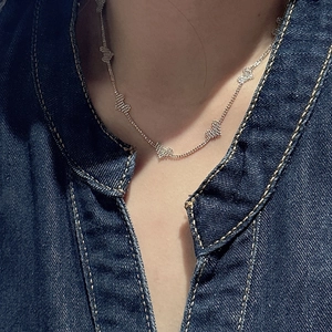 Minimalist S925 sterling silver necklace with heart charms worn on a neck
