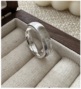 Close-up of S925 sterling silver ring with textured surface and hallmark engraving