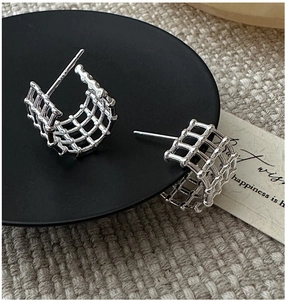 Macro shot of S925 sterling silver ear clips with hollow grid pattern and hallmark