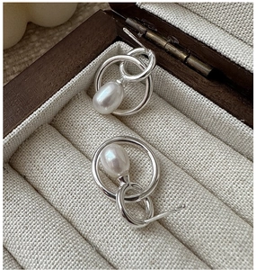 Detailed macro shot of vintage S925 silver multi-ring drop earrings with freshwater pearls