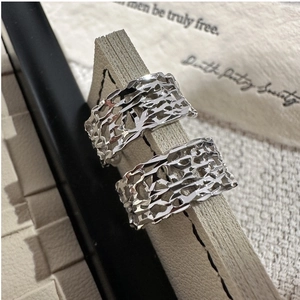 Macro shot of 925 silver rings set with irregular hollow texture and metallic luster