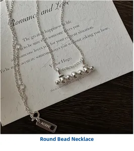 Detailed close-up of S925 sterling silver beaded bar necklace and AG925 hallmark tag