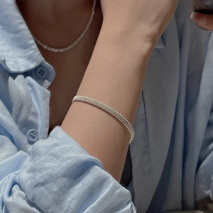 Minimalist S925 sterling silver woven texture bracelet worn on a female wrist