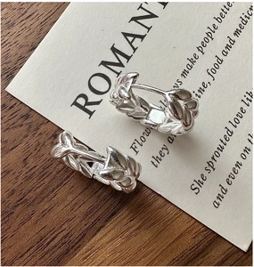 Detailed close-up of S925 silver hoop earrings with vintage wheat leaf engravings