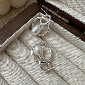 Elegant S925 sterling silver drop pearl earrings with double-loop design on jewelry tray