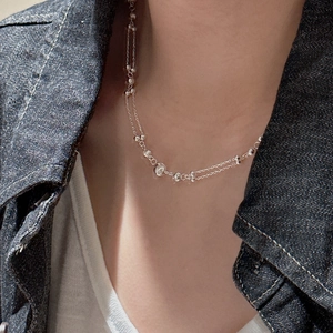 S925 sterling silver double-layer necklace with cat-eye beads on a denim jacket model