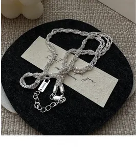 Detailed view of S925 sterling silver braided necklace chain with an AG925 hallmark tag