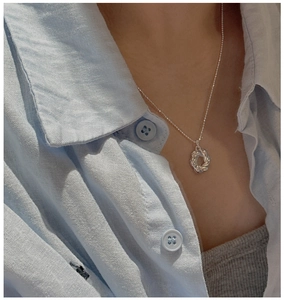 Dettaglio della collana a croissant in argento sterling S925 su modella con camicia