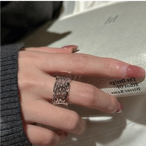 Detailed close-up of S925 sterling silver ring with hollow texture on a person's finger