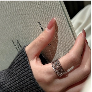 Close-up of S925 sterling silver hollow mesh ring with intricate CNC weave texture