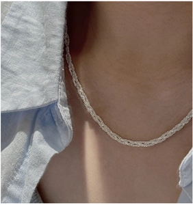 Macro view of S925 sterling silver braided chain necklace with sparkling snowflake texture