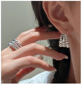 Macro shot of S925 sterling silver beaded ring and earrings with faceted disco ball texture