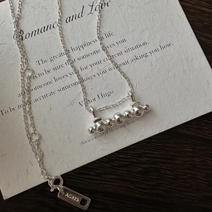 Minimalist S925 sterling silver necklace featuring a horizontal row of five polished beads