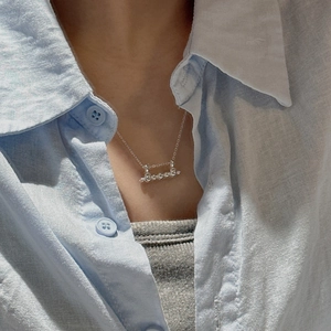 S925 sterling silver minimalist bar necklace with small beads on a female model