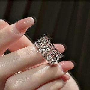 Macro view of wide silver hollow-out geometric ring with CNC multi-faceted cut finish