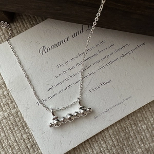 Elegant S925 sterling silver necklace featuring five beads pendant on artistic paper
