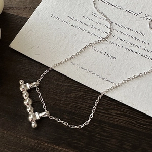 Minimalist S925 sterling silver bar pendant necklace on elegant poetry paper background
