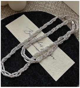 Detailed macro view of an S925 sterling silver woven snowflake necklace with lobster clasp