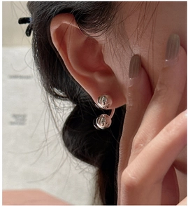 Close-up of S925 sterling silver ball earrings showing mirror finish and curved design