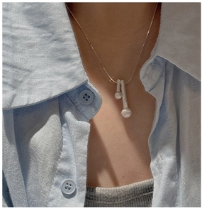 Détail du pendentif bâtonnet minimaliste en argent S925 brossé porté par un mannequin