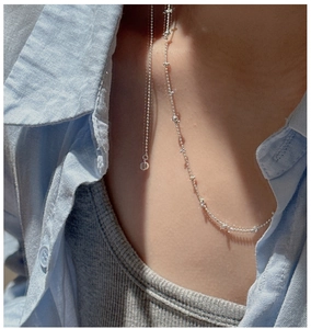 Detail of S925 sterling silver lariat necklace on model with shimmering zircon accents