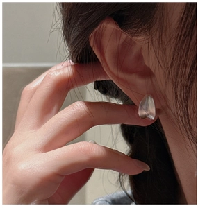 Detail shot of vintage 925 sterling silver C-shape earrings with a matte brushed texture