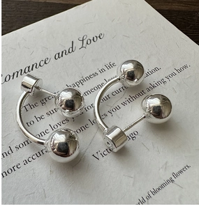 Close-up of S925 sterling silver hallmark on minimalist geometric C-shaped bead earrings