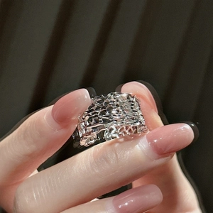 Elegant S925 sterling silver hollow woven ring on model hand with dark background