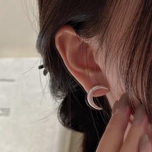 Elegant S925 sterling silver crescent moon earrings with vintage matte finish on model
