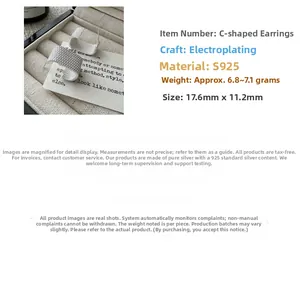 Macro detail of S925 sterling silver C-shaped earrings with vintage textured finish