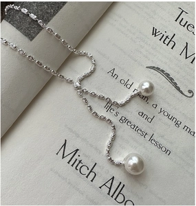 Close-up of S925 sterling silver Y-shaped necklace with elegant white pearl tassels