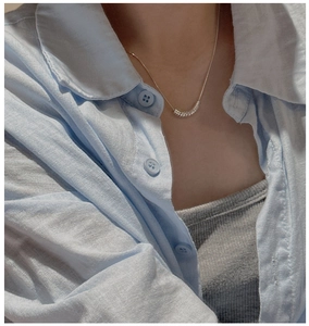 Close-up of S925 sterling silver geometric circle pendant on a delicate snake chain