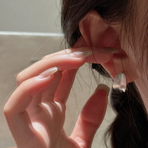 925 silver matte C-shaped earrings with abstract curved leaf design on model