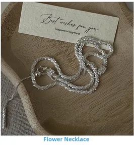 Detail of S925 silver necklace with textured cauliflower link chain on a wooden plate