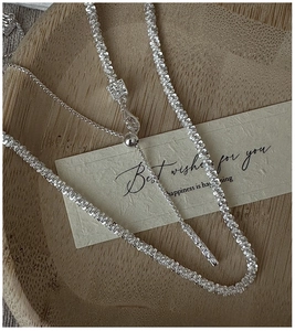 Macro detail of S925 sterling silver square weave chain with adjustable slider clasp