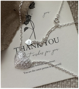Detailed close-up of 925 sterling silver heart pendant with unique dotted texture finish