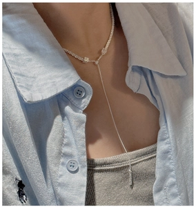 Detailed close-up of a shimmering S925 sterling silver Y-shaped tassel necklace for women