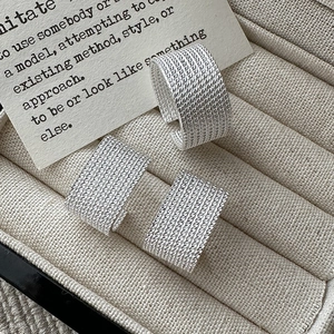 Set of three vintage S925 sterling silver rings with textured woven pattern on velvet tray