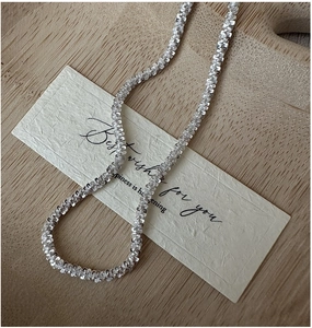 Close-up of S925 sterling silver chain featuring a textured glitter finish and metallic luster
