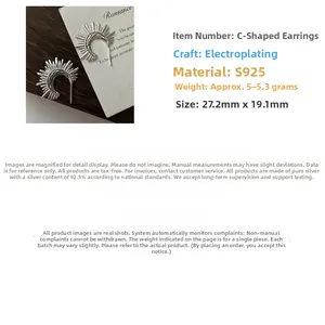 Macro detail of S925 sterling silver fan-shaped earrings with vintage sunburst texture