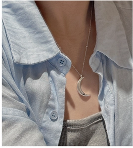 Detail of S925 sterling silver moon pendant with black zircon on a silver chain