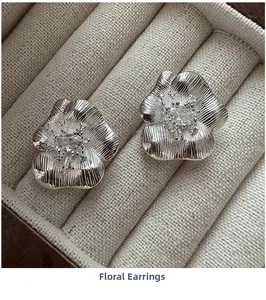 Macro shot of S925 silver flower earrings with zircon center in a jewelry box