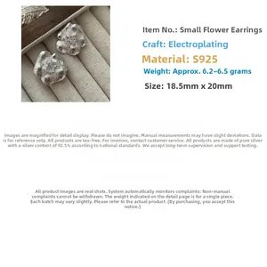 Macro shot of 925 sterling silver flower earrings with fine vintage petal textures