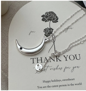 Detailed view of 925 sterling silver crescent moon pendant with matte finish and AG925 stamp